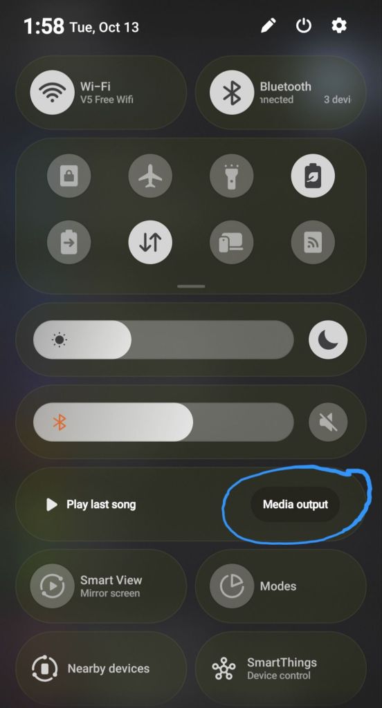A smartphone's quick access menu displaying Wi-Fi, Bluetooth settings, and media output options, with the current time and date at the top.